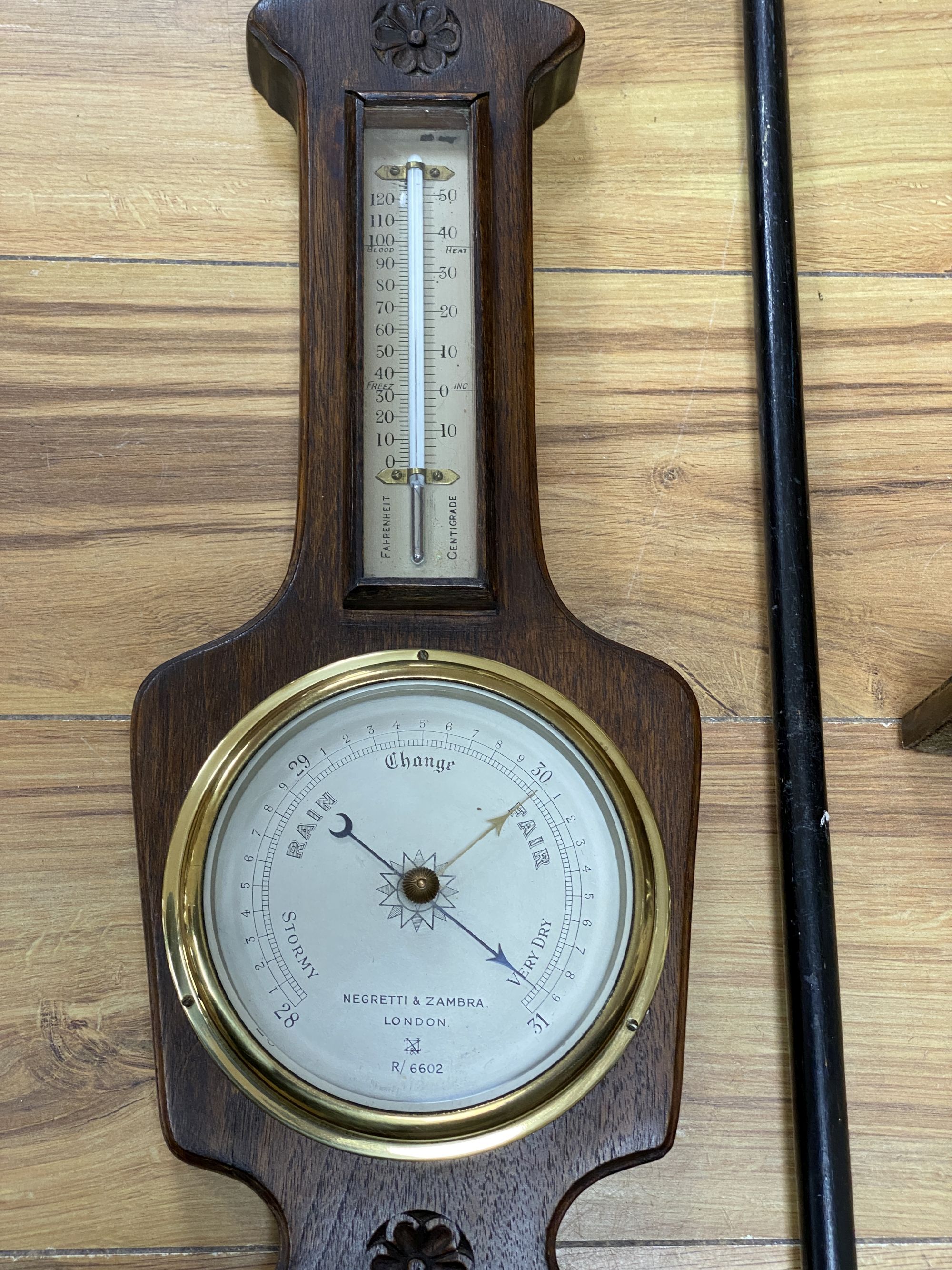 A Victorian silver mounted cane, a wheel barometer and a mantel barometer